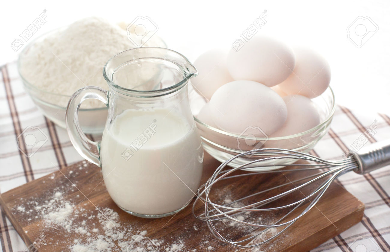 25110008-Baking-ingredients-with-milk-eggs-whisk-and-flour-on-the-table-Stock-Photo.jpg